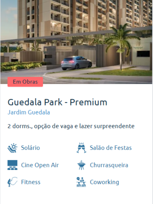 Fachada moderna do Guedala Park – Premium ao entardecer, com áreas de lazer e entrada principal iluminada.